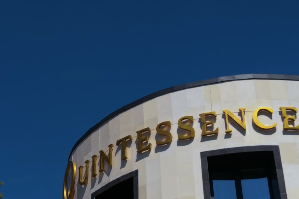 Gold Quintessence letters on the centre building