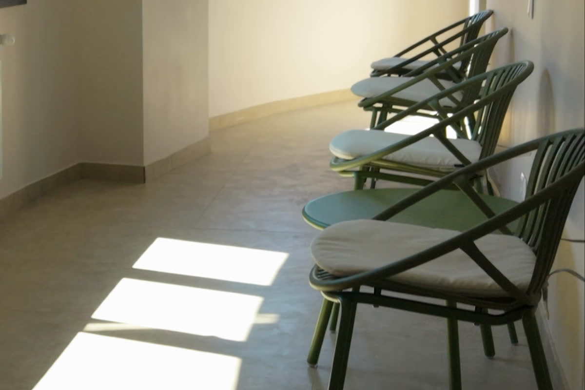 Armchairs along a sunlit corridor